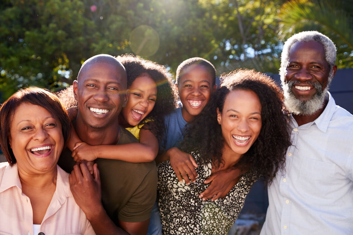 Smiling family gathered outdoors